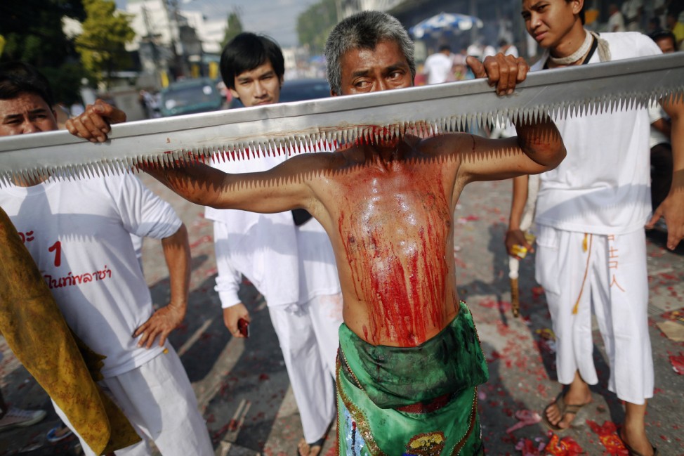 A devotee of the Chinese Bang Neow Shrine cut himself with a saw during a street procession of the annual vegetarian festival in Phuket