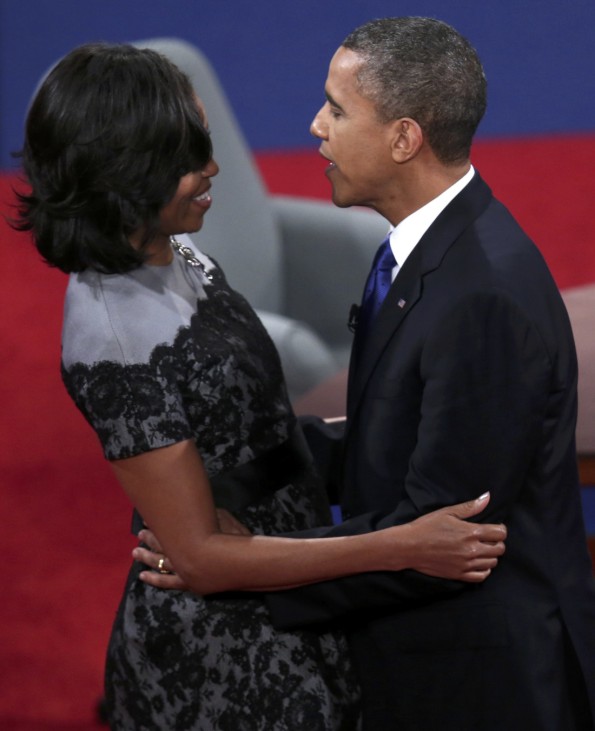 U.S. President Barack Obama embraces first lady Michelle Obama at the conclusion of the final U.S. presidential debate in Boca Raton