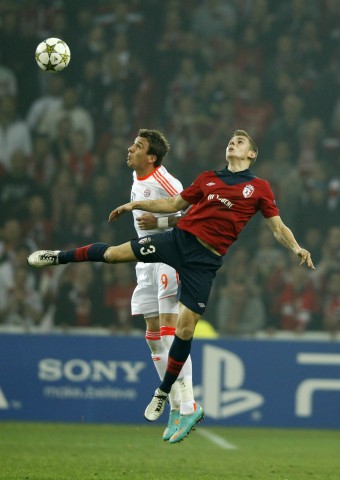 Lille's Digne challenges Bayern Munich's Mandzukic during their Champion's League Group F soccer match at the Lille Grand Stade stadium in Villeneuve d'Ascq