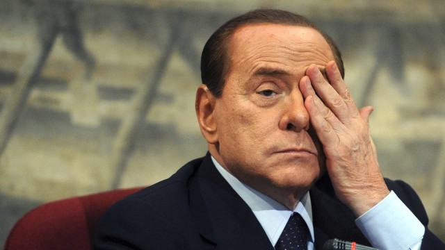 File photo of Italian PM Berlusconi gestures during a presentation of a book by Italian member of Parliament Scilipoti in Rome