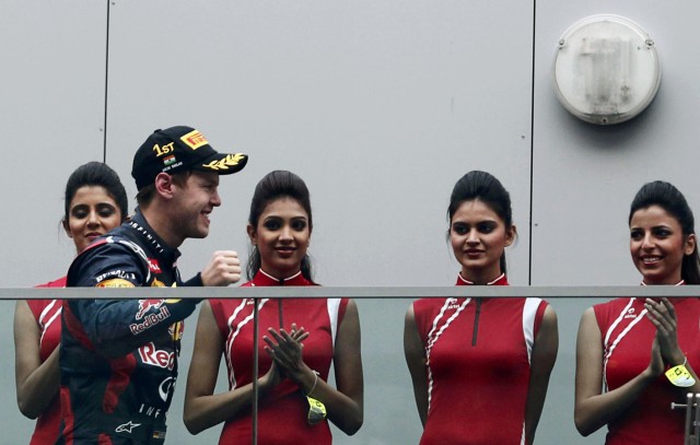 Red Bull Formula One driver Vettel walks towards the podium past grid lines after winning the Indian F1 Grand Prix at the Buddh International Circuit in Greater Noida