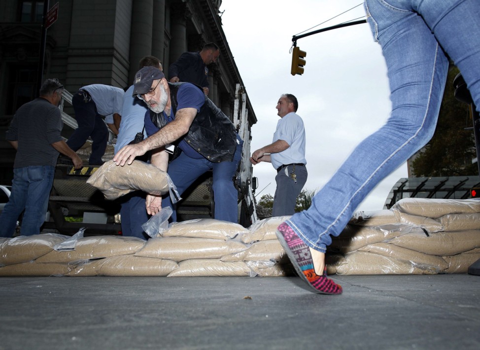 Workers place sandbags outside the MTA headquarters which is located in a vulnerable part of New York