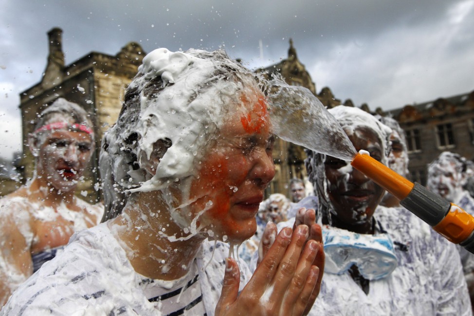 Foam is washed from the face of a St Andrews University student after the traditional Raisin Monday celebrations in St Andrews, Scotland