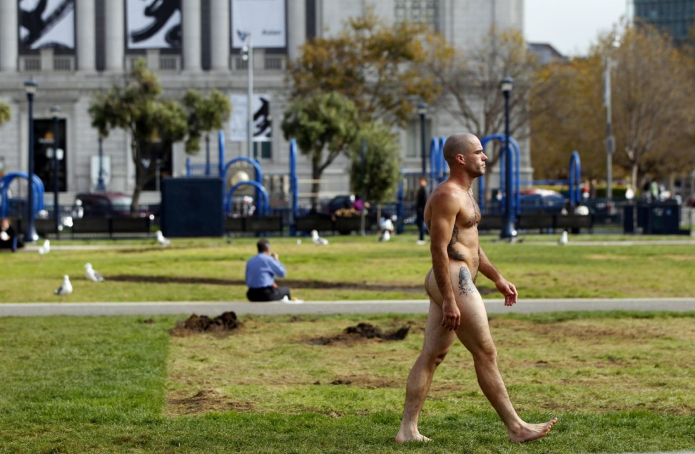 A man, who identified himself as Ocean, walks nude through Civic Center Plaza in San Francisco
