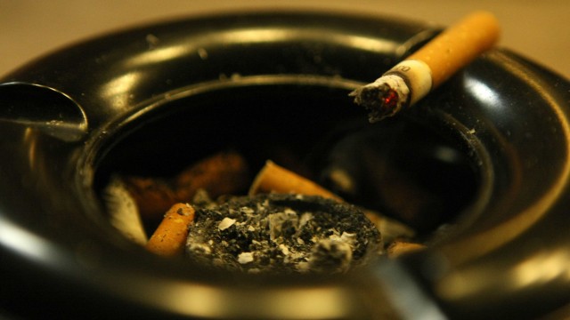 A cigarette lies in ashtray in front of a pub in Bensheim