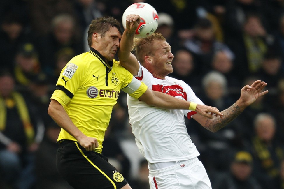 Borussia Dortmund's Kehl and Stuttgart's Holzhauser head a ball during the German first division Bundesliga soccer match in Dortmund