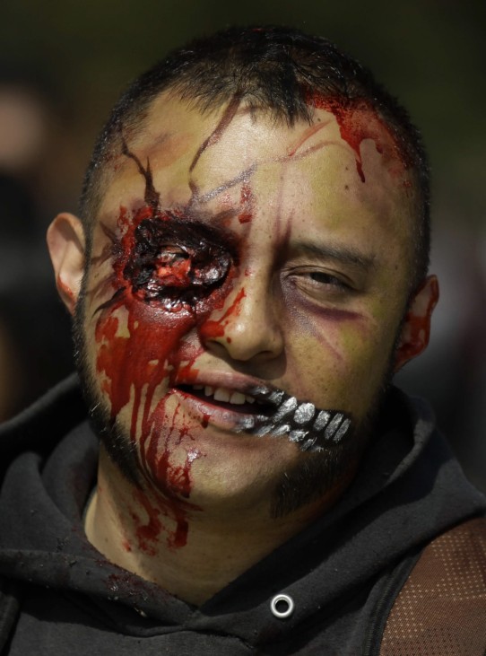 A man dressed as zombie participates in a Zombie Walk procession on the streets in Mexico City