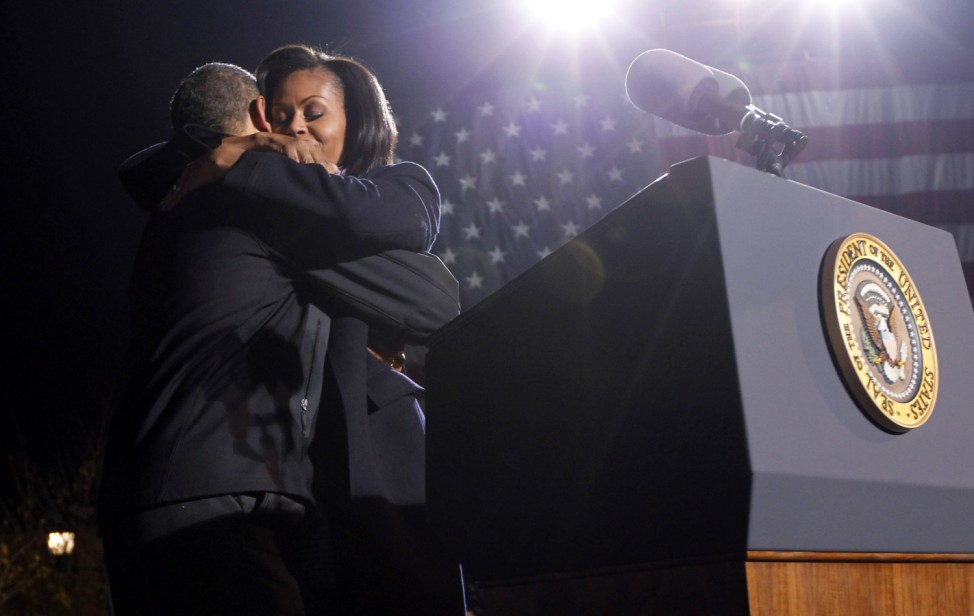 U.S. first lady Michelle Obama hugs her husband President Barack Obama at his final campaign rally in Des Moines, Iowa