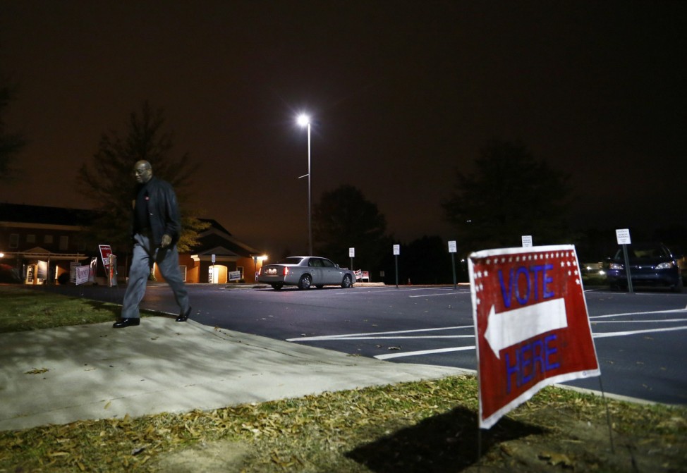 Bill Partlow, chief judge for precinct 140, arrives to begin opening the polling place during the U.S. presidential election in Pineville