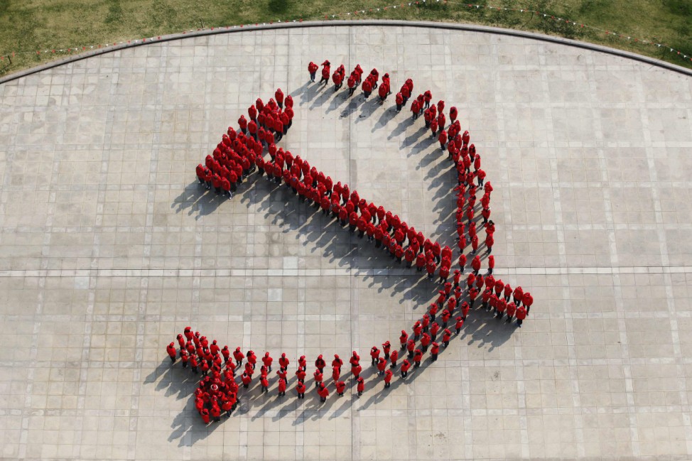 Fudan University's students form the Chinese Communist Party emblem, a hammer and sickle, to mark the upcoming 18th National Congress of the Communist Party of China in Shanghai