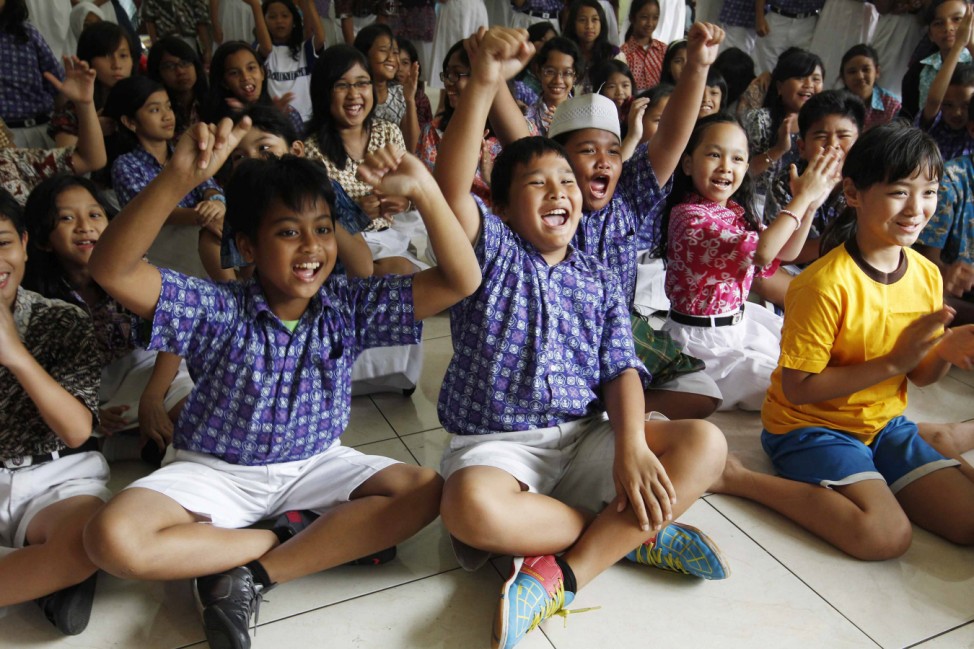 Students at State Elementary School Menteng 01, where U.S. President Barack Obama studied from 1970-1971, cheer in support of Obama while watching TV coverage of the U.S. presidential election in Jakarta