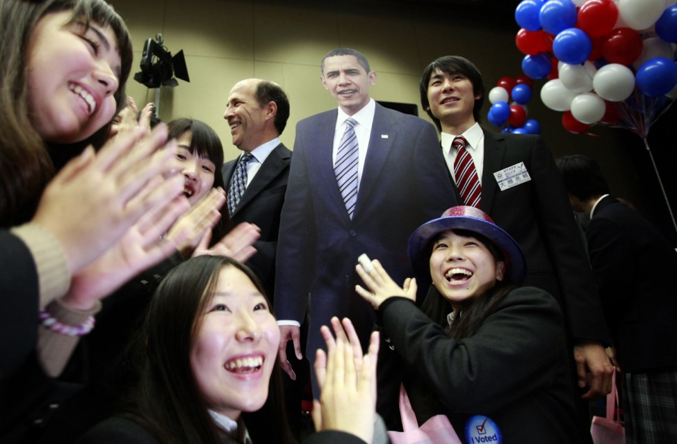 Japanese high school students pose around a cutout figure of U.S. President Barack Obama standing next to U.S. Ambassador to Japan John Roos, during an event to celebrate the results of the U.S. presidential election at the U.S. Embassy in Tokyo