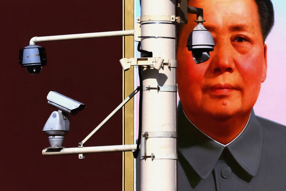 Security cameras are attached to pole in front of portrait of former Chinese Chairman Mao on Beijing's Tiananmen Square