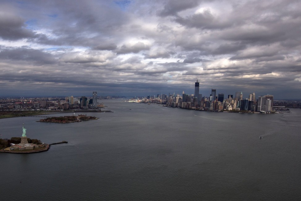 The Statue of Liberty, Liberty Island and Ellis Islands are seen to the left next to New York's Lower Manhattan skyline in this aerial image taken in New York