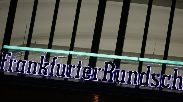 The logo of German newspaper Frankfurter Rundschau is lit at its headquarters in Frankfurt