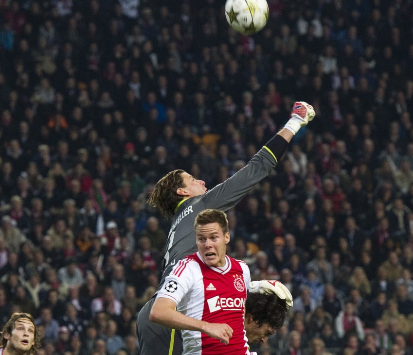 Borussia Dortmund's goalkeeper Roman Weidenfeller fights for the ball with Ajax Amsterdam's Niklas Moisander during their Champions League Group D soccer match in Amsterdam