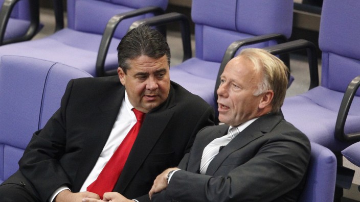 SPD leader Gabriel talks with the Green party parliamentary faction leader Juergen Trittin