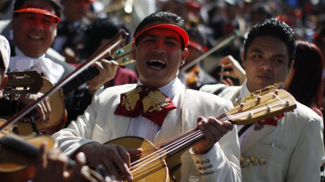 Mariachis play guitar during a pilgrimage to the Basilica of Our Lady of Guadalupe in Mexico City