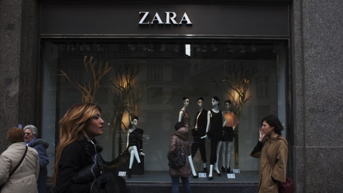 People walk by one of Zara's stores in central Madrid