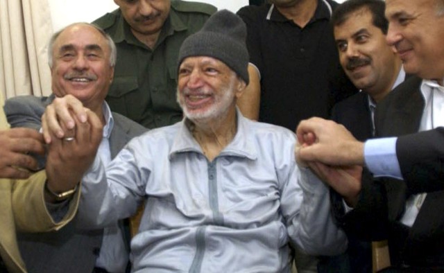 File photo of then Palestinian President Yasser Arafat sitting surrounded by doctors from Tunis, Egypt and Jordan in his office in the West Bank City of Ramallah