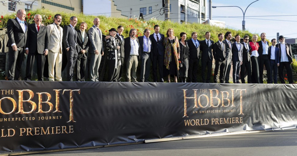 New Zealand director Jackson and cast members pose on a stage at the world premiere of 'The Hobbit - An Unexpected Journey' in Wellington