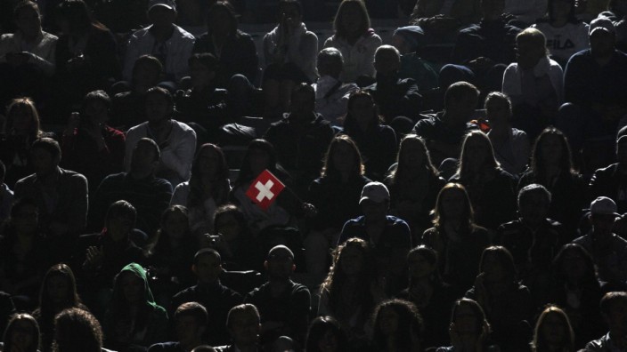File photo of tennis supporter holding Swiss national flag