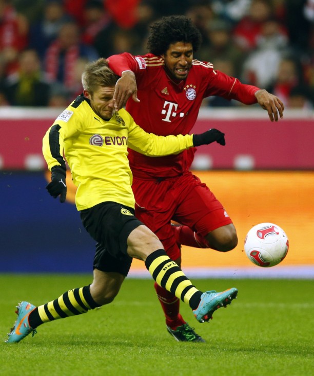 Dante of Bayern Munich challenges Jakub Blasczykowski of Borussia Dortmund during their German first division Bundesliga soccer match in Munich