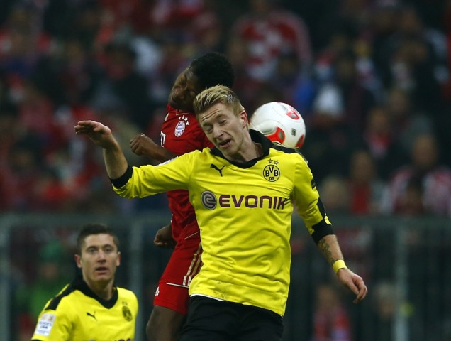 Munich's Alaba challenges Borussia Dortmund's Marco Reus during their German Bundesliga first division soccer match in Munich