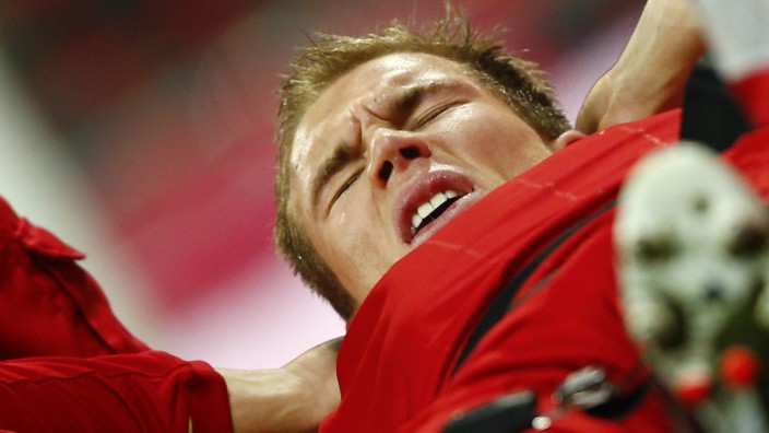 Badstuber of Bayern Munich grimaces in pain as he is carried off pitch during their German first division Bundesliga soccer match against Borussia Dortmund in Munich