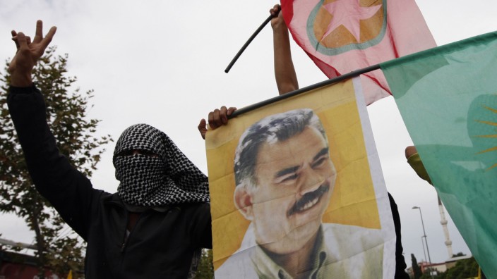 File photo of masked demonstrators displaying a picture of jailed Kurdish rebel leader Ocalan and PKK flags during a peace day rally in Istanbul