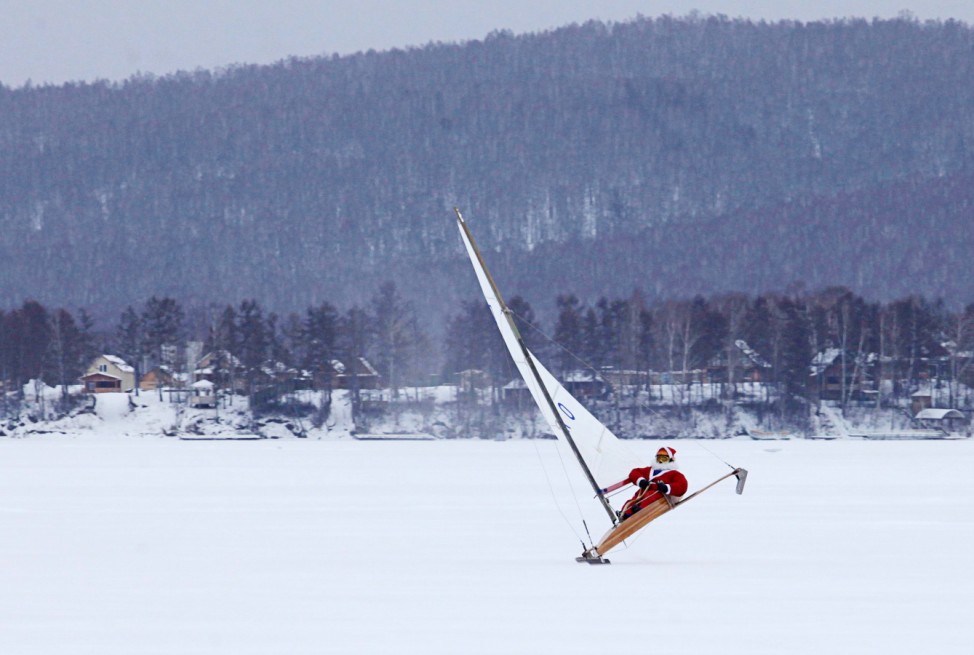 Shevchenko dressed as Santa Claus ice sails on the frozen Bolshoye lake near the village of Parnaya