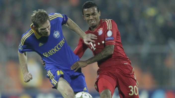 BATE Borisov's Hleb fights for the ball with Bayern Munich's Gustavo during their Champion's League Group F soccer match in Minsk's Dinamo Stadium