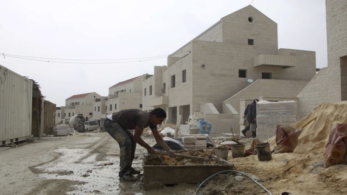Palestinian labourers work at a construction site in the Jewish settlement of Maale Adumim