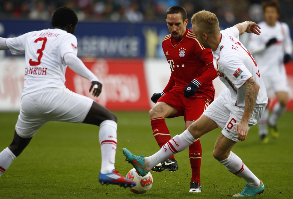 Augsburg's Sankoh and Vogt challenges Bayern Munich's Ribery during German Bundesliga soccer match in Augsburg