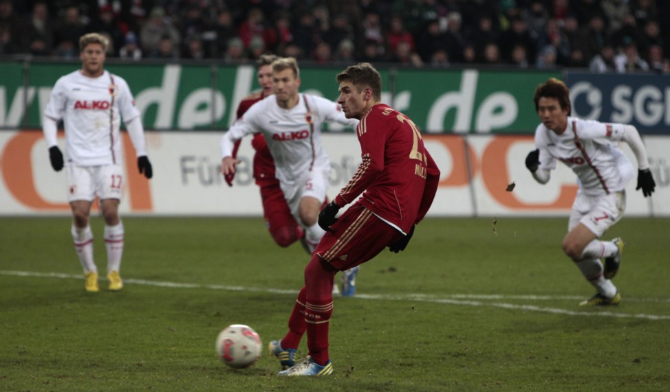 Bayern Munich's Mueller scores goal against Augsburg during German Bundesliga soccer match in Augsburg