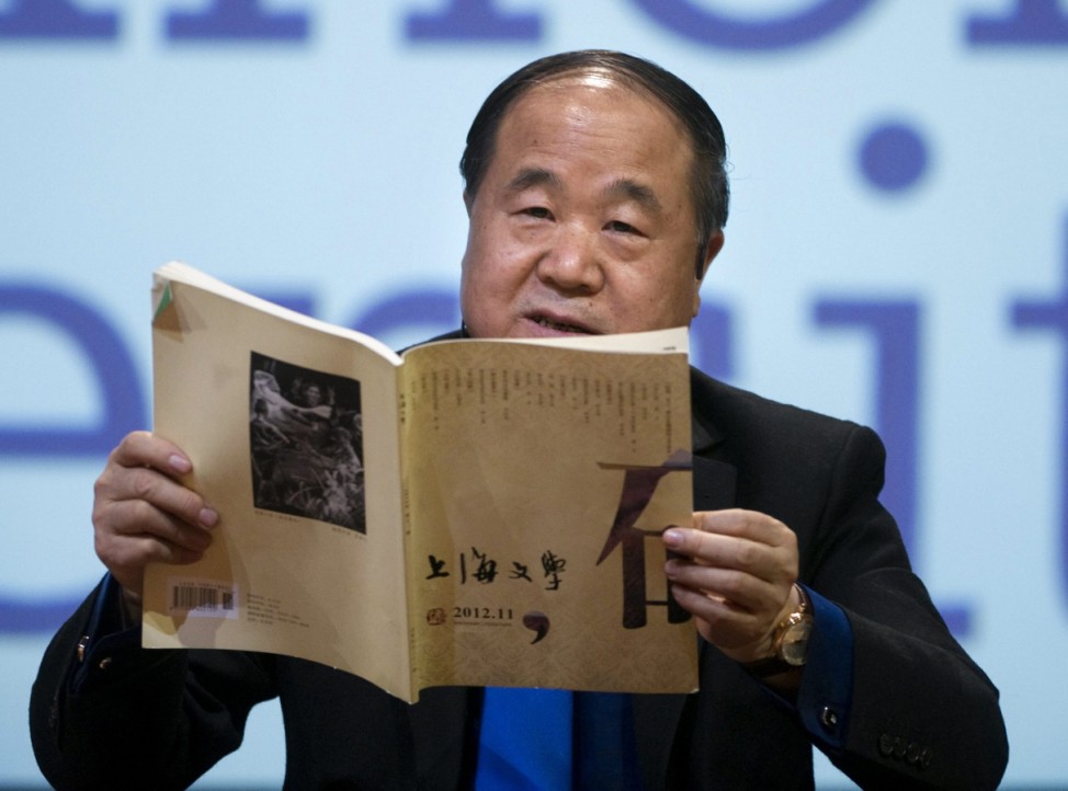 2012 Nobel Literature Prizewinner Mo of China reads from a book during a public reading of his works at Aula Magna