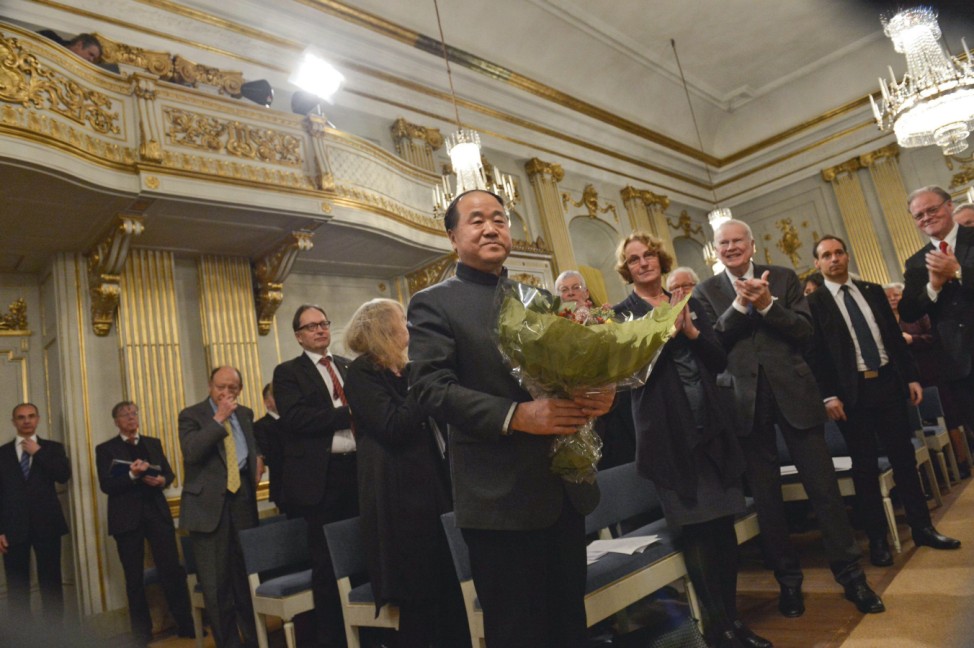 2012 Nobel Literature Prize laureate Mo of China receives flowers and applause from members of academy during traditional Nobel lecture at Royal Swedish Academy