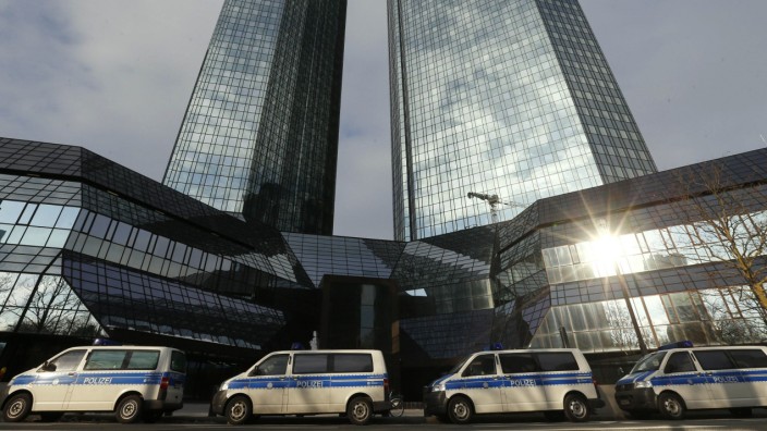 Police vehicles are parked outside the headquarters of  Deutsche Bank AG in Frankfurt