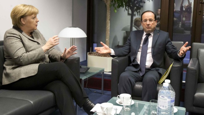 German Chancellor Merkel speaks with French President Hollande during a meeting on the sidelines of an EU summit in Brussels