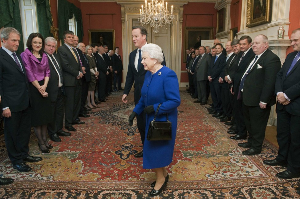 Britain's Queen Elizabeth walks with Prime Minister David Cameron as members of the cabinet watch at Number 10 Downing Street in London