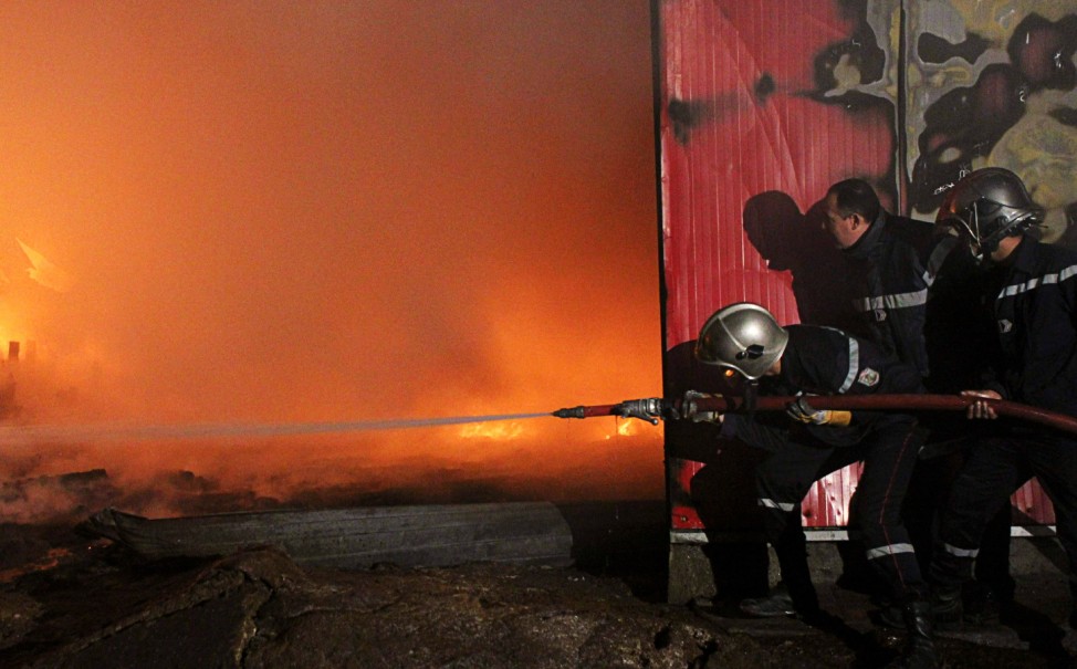 Firefighters try to extinguish a fire that broke out in a factory in Akouda