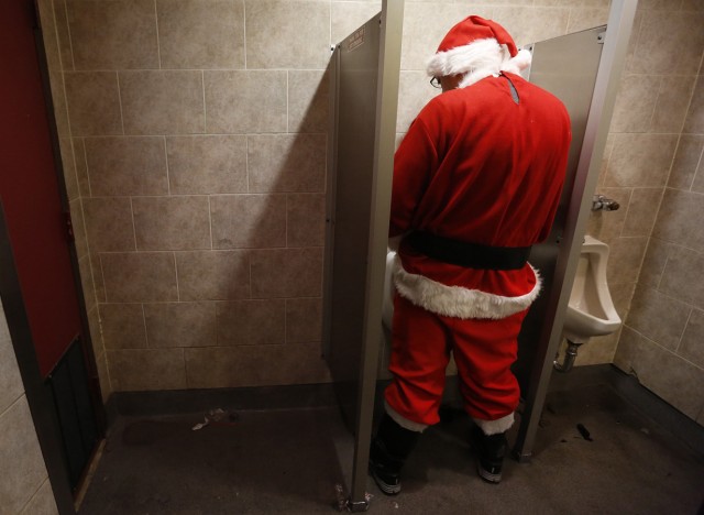 A reveler uses the bathroom at Smith's Bar and Grill during SantaCon in New York
