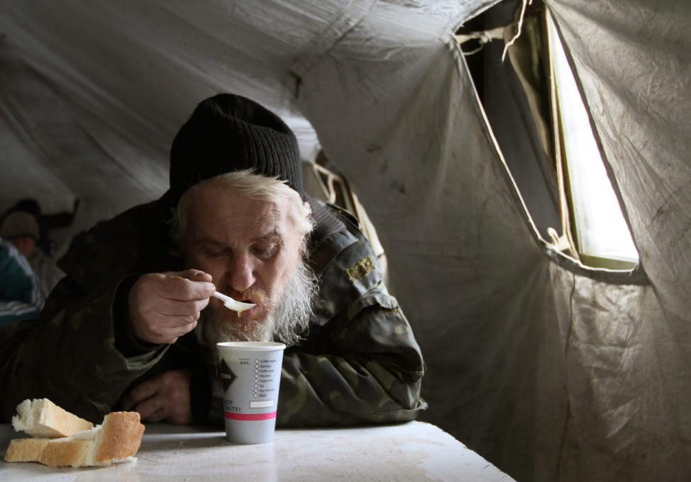 Homeless people get free hot food in Donetsk.
