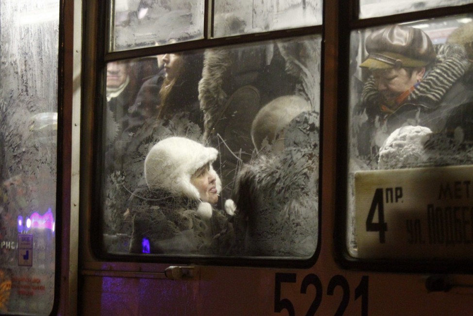 People are seen through windows, covered with hoarfrost, in Moscow