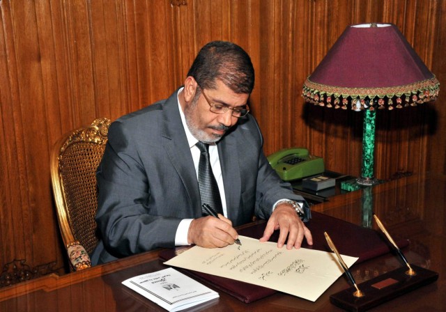 Egyptian President Morsi enforces the new constitution