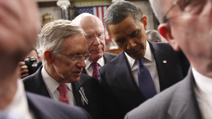 President Barack Obama talks with Senate Majority Leader Harry Reid and Sen. Patrick Leahy after delivering his State of the Union address on Capitol Hill in Washington