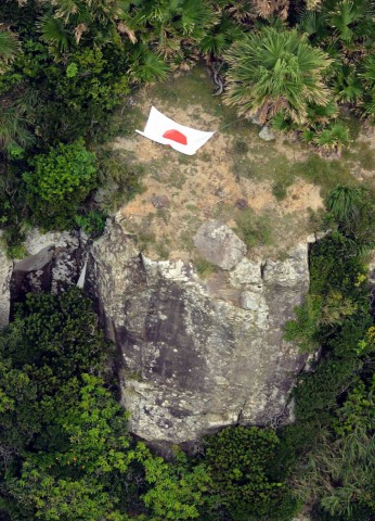 Aerial photo from Kyodo News shows Japan's national flag on one of a group of disputed islands known as Senkaku in Japan and Diaoyu in China, in the East China Sea