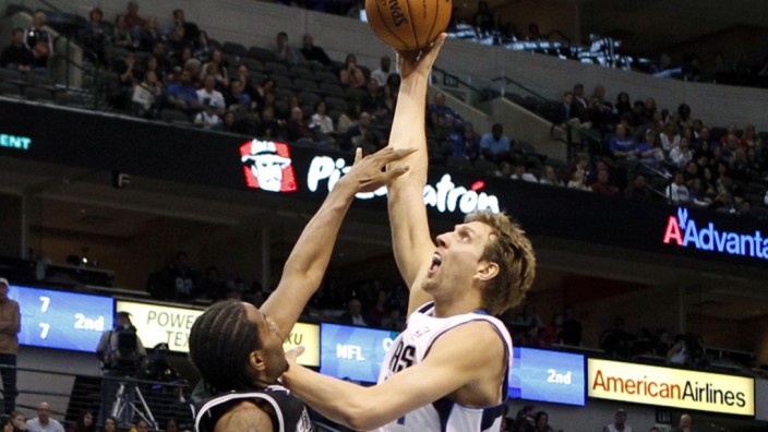 Mavericks forward Nowitzki shoots over Spurs forward Leonard during their NBA basketball game in Dallas