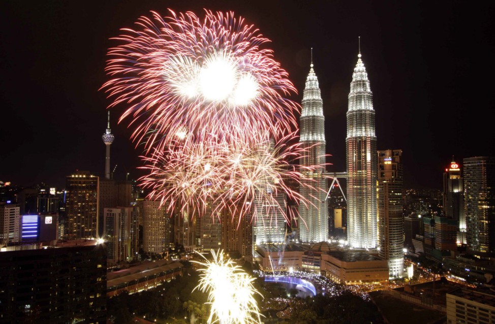 Fireworks explode near the Malaysia's landmark Petronas Twin Towers during New Year celebrations in Kuala Lumpur