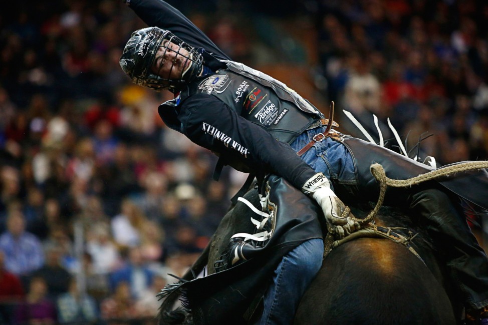 A competitor rides a bull during the Professional Bull Riders invitational at Madison Square Garden in New York